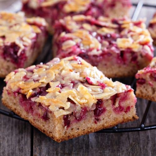 Berry cake bars with caramel almond topping  on a cooling rack