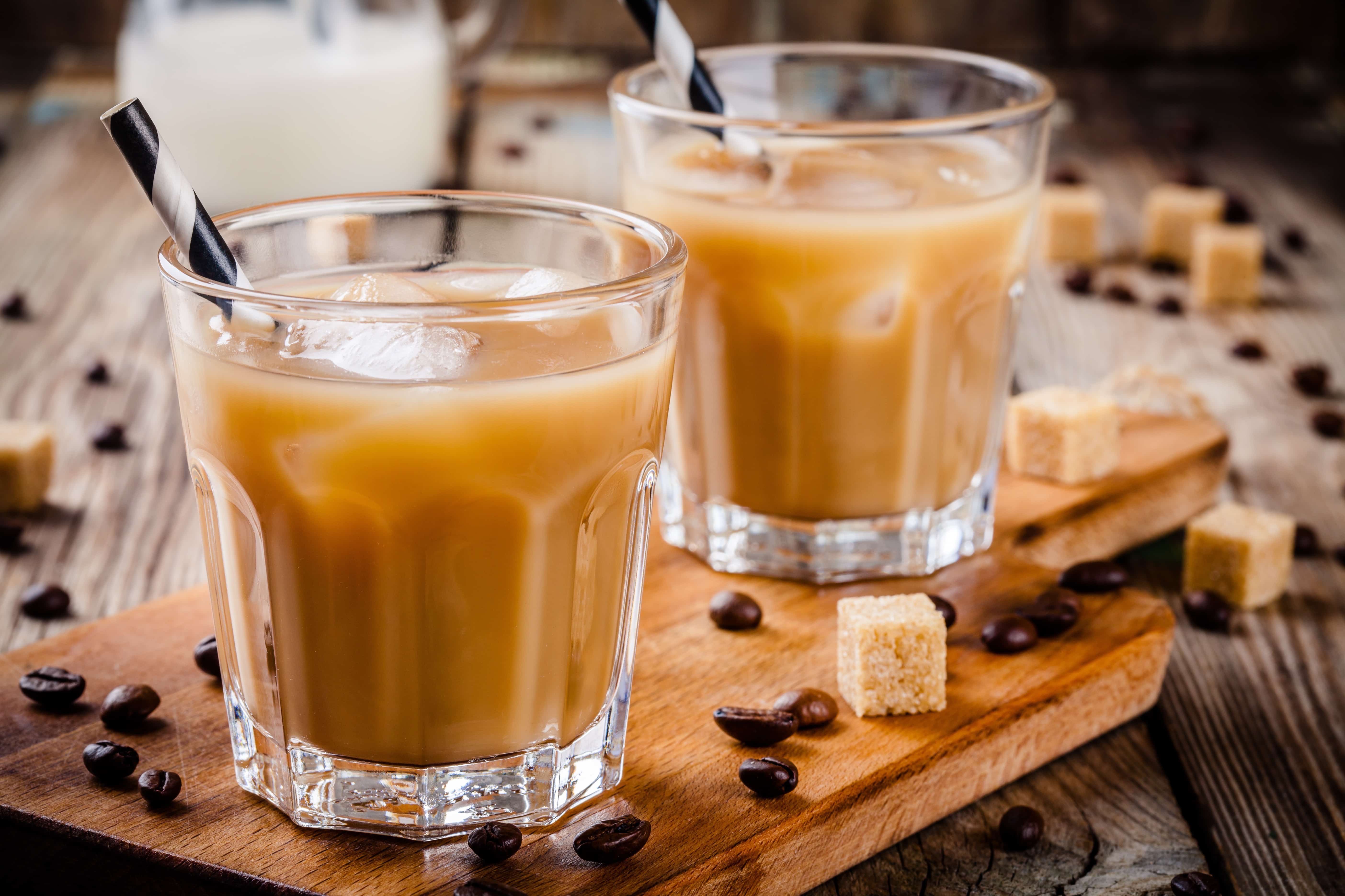 Iced coffee in glass on wooden table