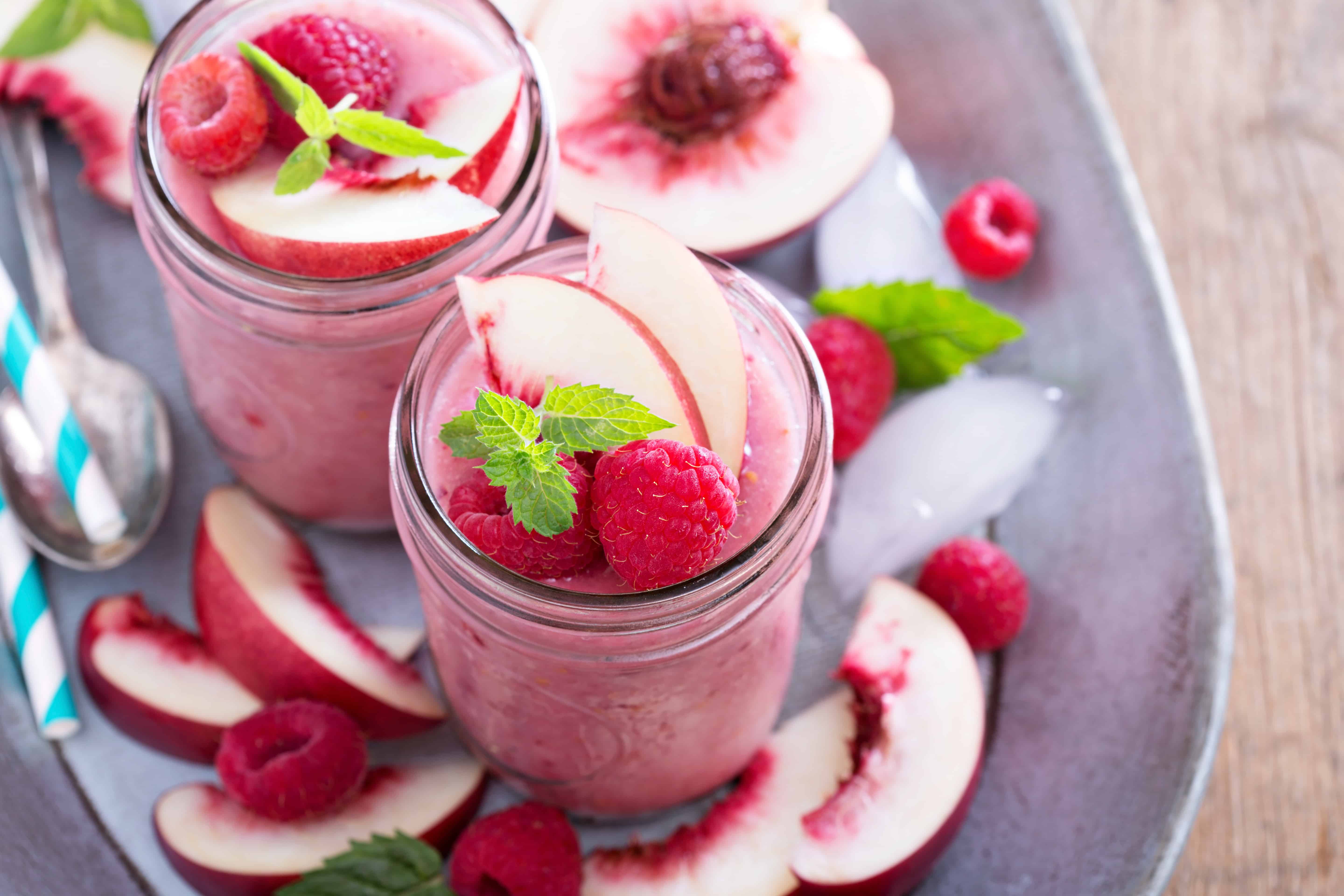 Raspberry and white peach smoothie in mason jars