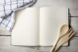 Blank recipe book on wooden table