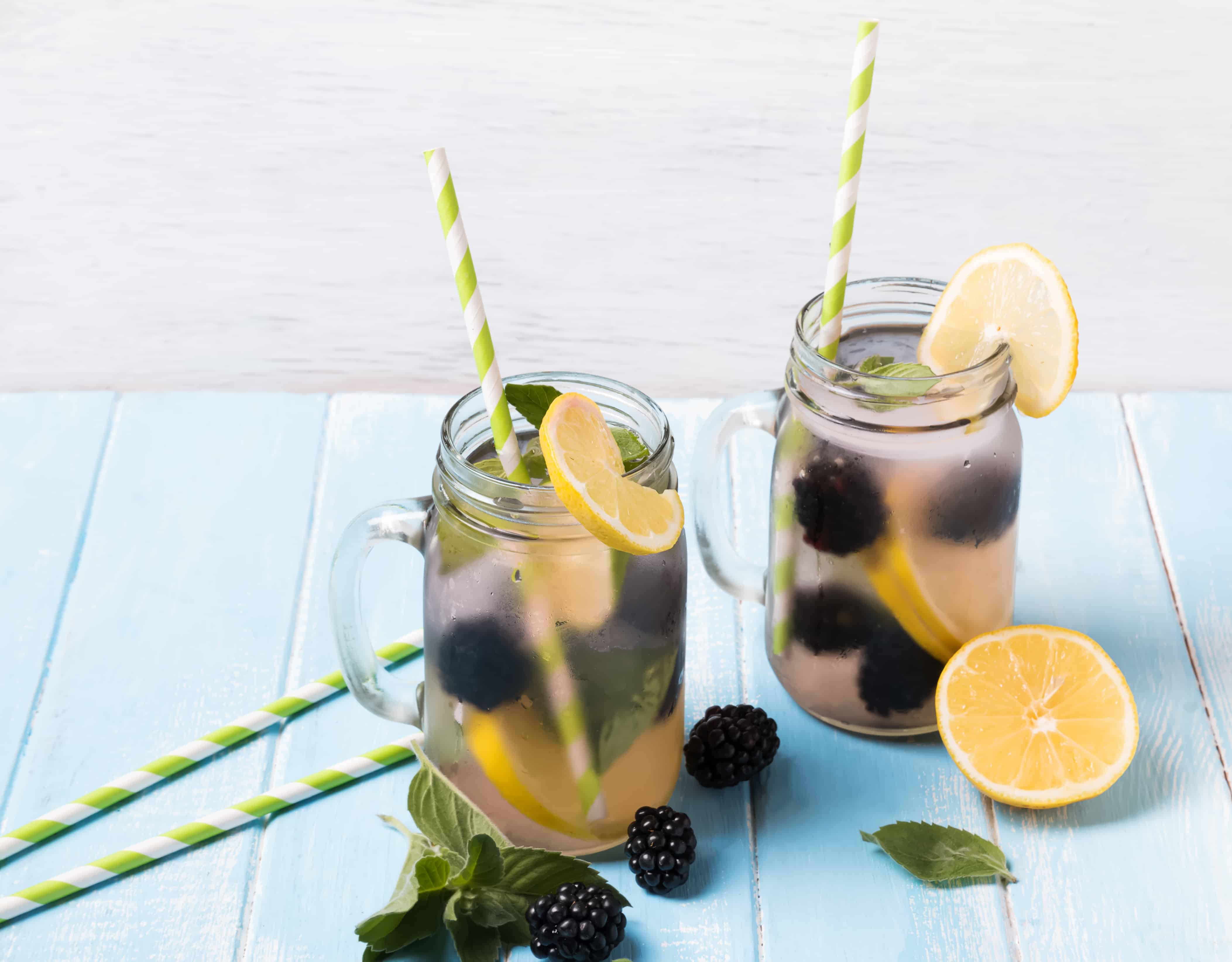 Detox water with blackberry and lemon in glass jars